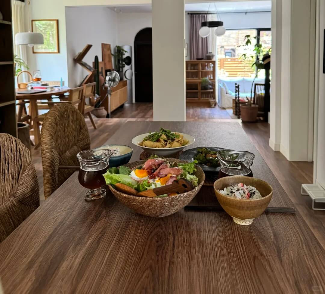 Dining table with food and drinks in a modern living room setting